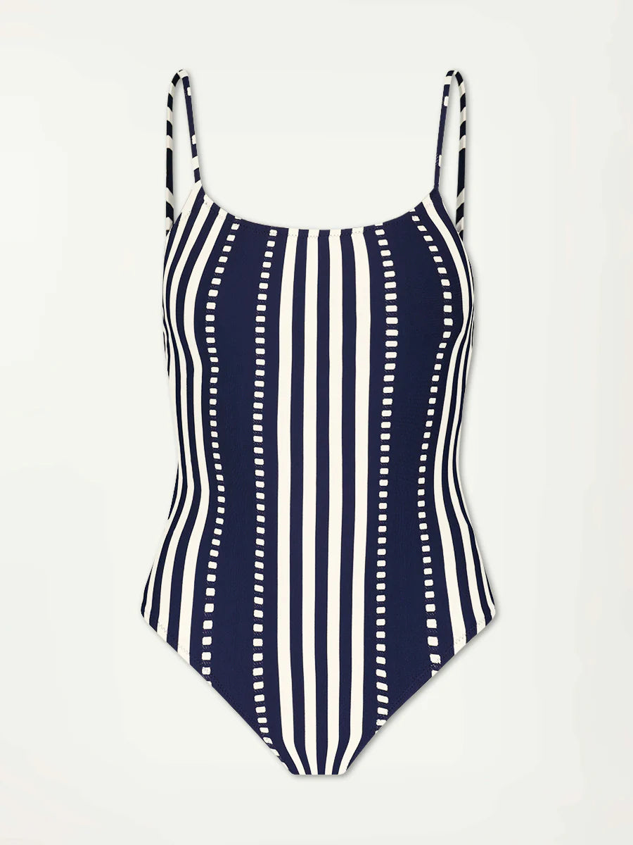 The lemlem Elene One Piece by Lemlem is a classic swimsuit with vertical black and white stripes, adjustable spaghetti straps, and an interior shelf bra for support.