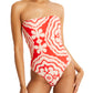 A person is confidently wearing the Lemlem Dinha One Piece by Lemlem, a strapless red and white patterned swimsuit with a sleek neckline that adds elegance.