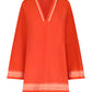 The Lemlem Raey Dress by Lemlem is a chic, bright orange tunic hand-woven in Ethiopia. It features a V-neck, long sleeves, and white zigzag trim on the neckline, cuffs, and hem, along with delicate sheer stripes for elegance.