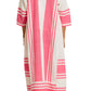 Someone is seen from the back wearing Lemlem’s Fana Caftan, a loose-fitting, long white dress with pink vertical and horizontal stripes made from hand-spun cotton.