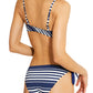 A person is seen from behind wearing Lemlem's Sara Tie Front Top and Lucy Bottom, a navy and white striped bikini with a stylish side tie bottom for an ideal fit.