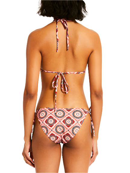 Rear view of a person wearing the Lemlem Malia Top and Rekka Bottom Bikini, featuring a colorful pattern with string ties and a halter neck.