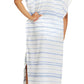 A woman wearing Lemlem's Dalila Caftan, a hand-woven dress with white and blue stripes.
