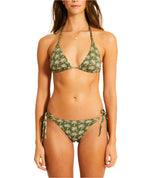 A person is wearing the Lemlem Malia Top and Rekka Bottom Bikini, featuring a green base with a white leaf pattern, adjustable string ties, and a triangular bikini top, shown from the front.
