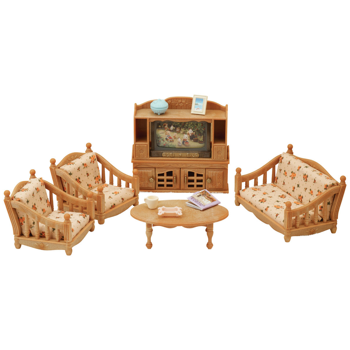 The Calico Critters Comfy Living Room Set includes two armchairs, a sofa, coffee table, and TV stand—all designed with wood-toned finishes and floral upholstery. This miniature furniture set comes with small accessories for the tables and TV stand, making it a perfect addition to any Calico Critters dollhouse.