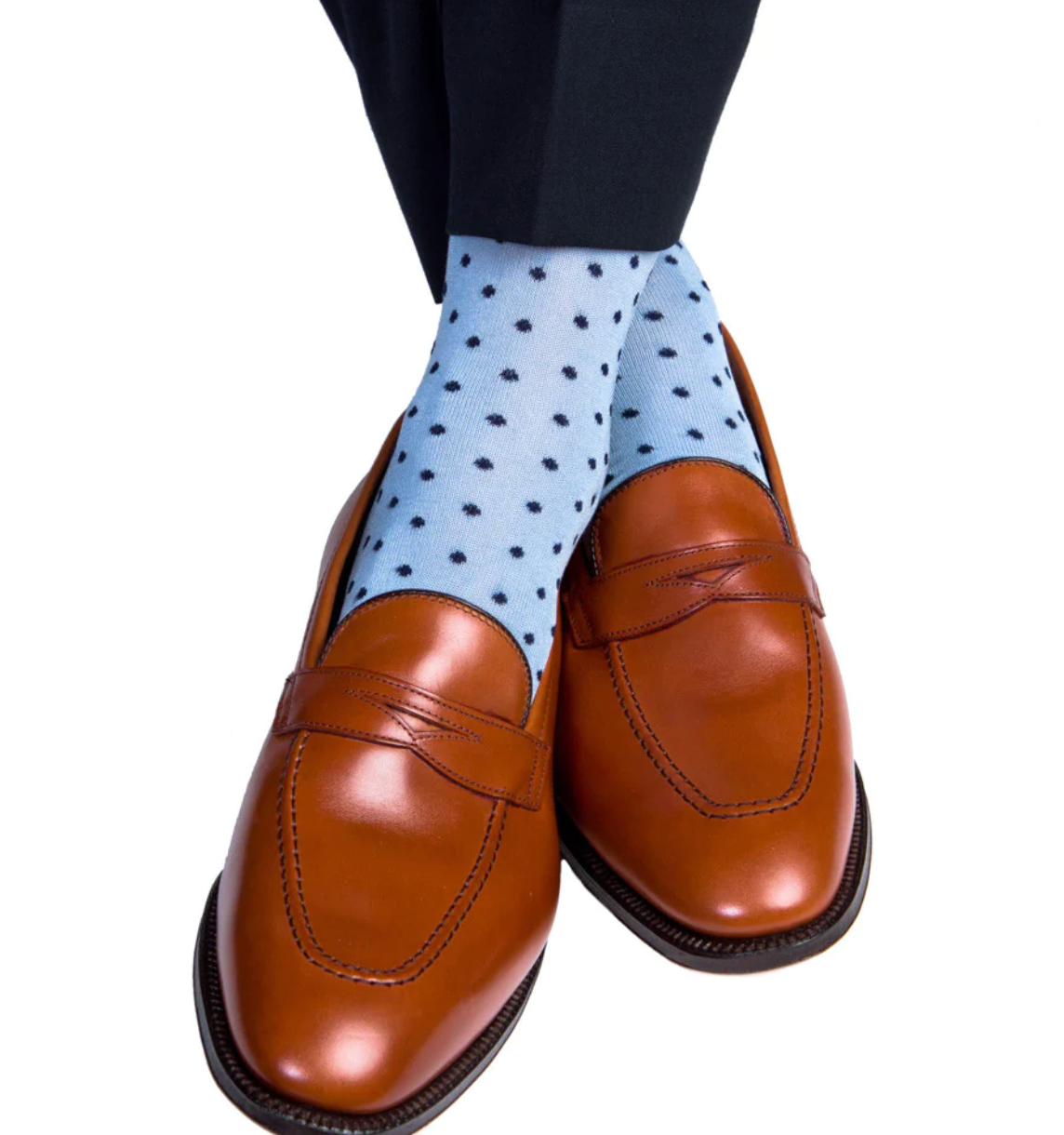 Brown leather loafers are paired with Dapper Classics' Dot Mid Calf Socks, showcasing a light blue polka dot design and stay-up fit, complemented by dark pants.