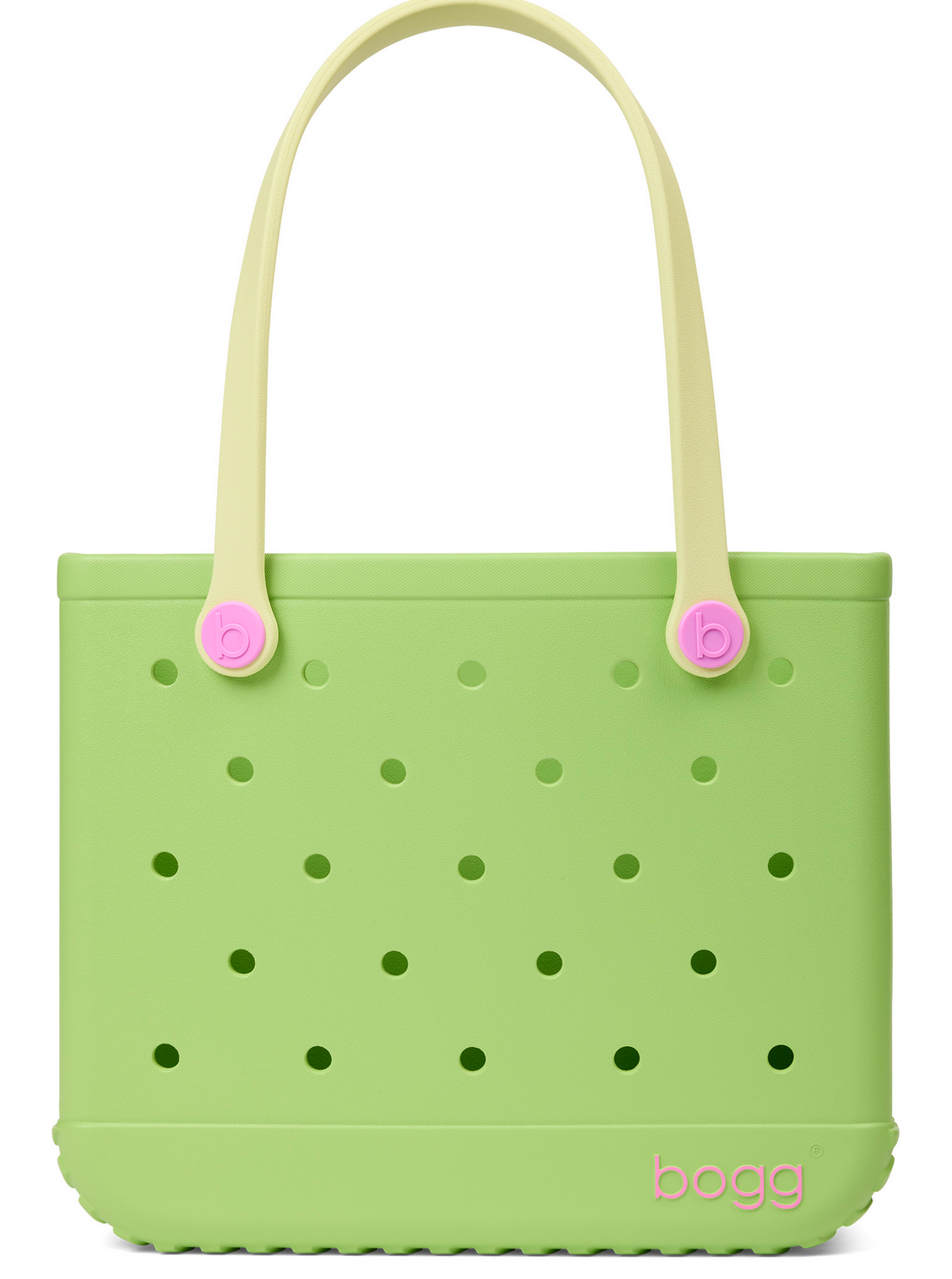 A light green Baby Bogg® Bag tote from Bogg Bags, featuring evenly spaced holes, cream-colored handles with pink accents, and the word “bogg” printed in pink in the lower corner. This durable bag is fully washable for easy care and long-lasting use.
