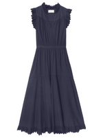 The Britta Dress by Xirena is a sleeveless navy cotton poplin dress featuring ruffle details at the collar and hem, cap sleeves, a gathered waist, and a V-neckline.