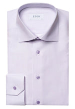 A neatly folded Eton Light Purple Checked Shirt, crafted from Cotton & TENCEL™, with a label inside the collar that reads "ETON." The shirt features a classic micro-check pattern, an elevated essential with a classic collar and buttoned cuffs in a slim fit.