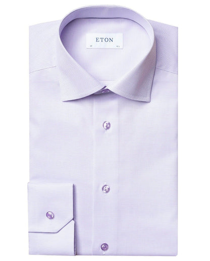 A neatly folded light purple Eton Twill Shirt, Slim Fit, featuring a versatile collar with an "ETON" label on the inside. This wrinkle-free shirt is designed for easy care, making it perfect for any occasion.