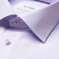 Close-up of the Eton Solid Signature Oxford Shirt in light purple cotton, featuring a button-down collar and button detailing, with the Eton brand label visible inside the collar. This crease-resistant shirt offers timeless style and easy-care convenience.