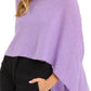 A woman wearing a purple Alashan Cashmere Cashmere Dress Topper Poncho.