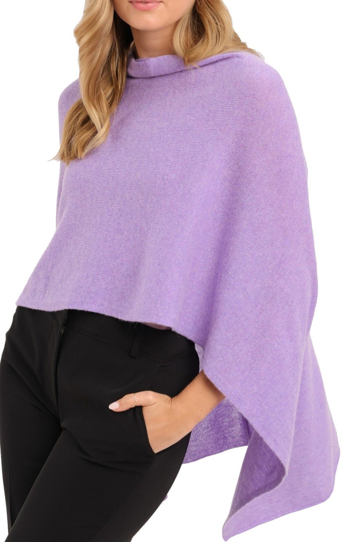 A woman wearing a purple Alashan Cashmere Cashmere Dress Topper Poncho.