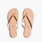 Lily Glosses Sandals by Tkees are nude flip-flops with thin straps, crafted from luxurious Brazilian leather and displayed on a plain white background.
