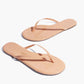 Lily Glosses Sandals by Tkees: glossy nude flip-flop sandals with thin straps, crafted from sleek patent leather, displayed on a white background.