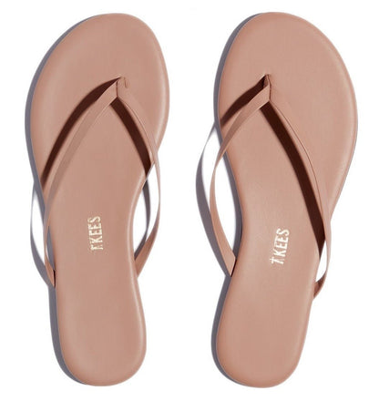 This pair of pink flip flops is part of the Tkees Lily Nudes Sandals collection.