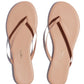 A pair of nude Tkees Lily Nudes Sandals from the Tkees Nude collection with the words 'node beach'.