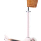 A pink child's Banwood Scooter with a wicker basket attached to the handlebars, featuring an Easy Ride Steering System.