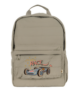 The Konges Slojd Juno Quilted Backpack, in beige, features an embroidered racing car design with "My pace is race." It's equipped with a front pocket, chest strap for secure carrying, and a bottle pocket for on-the-go hydration.