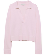 The Simkhai Cashmere LS Polo Sweater in light pink features long sleeves, a deep V-neck with collar, and ribbed cuffs and hem, shown against a plain white background.