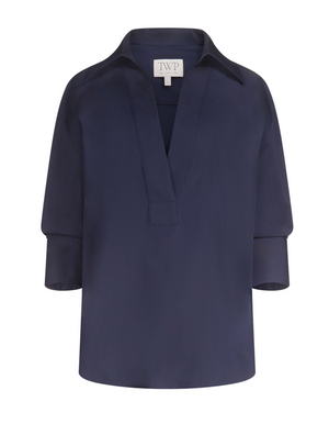 TWP Polo Shirt in navy blue featuring long sleeves, a deep V-neck, wide collar, and cuffed sleeves displayed on a plain white background.