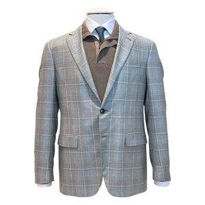 The Canali Kei Lined Grey/Brown Plaid Blazer is shown on a mannequin over a brown collared shirt, white dress shirt, and black dotted tie.