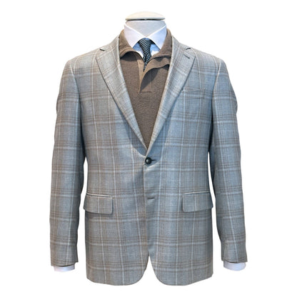 The Canali Kei Lined Grey/Brown Plaid Blazer is shown on a mannequin over a brown collared shirt, white dress shirt, and black dotted tie.