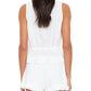 A woman is shown from the back wearing the sleeveless white Emma Top by Xirena, featuring a peplum waist and delicate lace inset details.