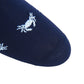 A close-up of a navy sock from Dapper Classics displays a repetitive design of white crabs, masterfully knitted using breathable fabric. This product is known as the Dapper Classics Lobster and Crab Mid Calf Socks in Navy and White.