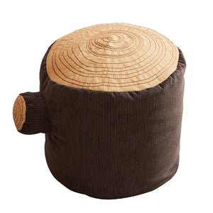 The Asweets Tree Stump Poof, by Asweets, is a charming corduroy ottoman designed to mimic the appearance of a tree stump. With its brown fabric and circular stitching on top, this poof is perfect for bringing comfort and whimsical style to your playroom.