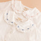 The Kidiwi Baby Girls' Lorena Blouse features off-white plumetis fabric and a delicate Peter Pan collar.