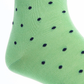 A close-up of Dapper Classics' Dot Mid Calf Socks showcases their green, durable fabric adorned with small black polka dots.