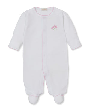 The Kissy Kissy Baby Premier Sweet Sheep Footie is a white long-sleeve footed onesie from the Sweet Sheep Collection, crafted from soft Peruvian cotton. It features delicate pink stitching and small pink flower hand embroidery on the left chest.
