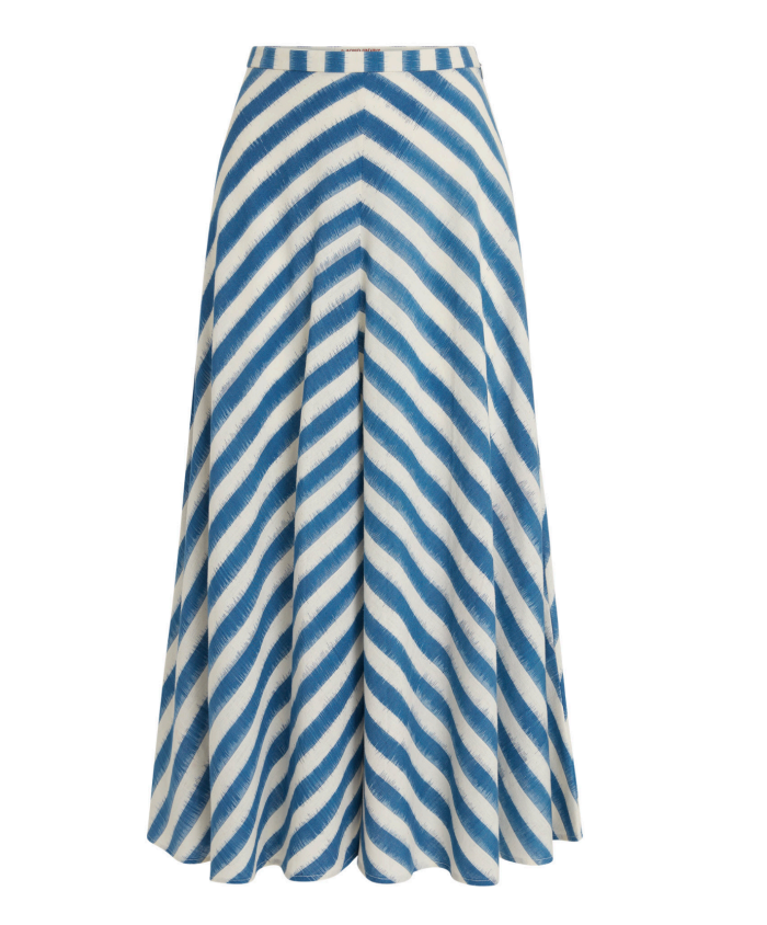 The Emporio Sirenuse Marta Ikat Stripe Skirt is a blue and white summer skirt with a chevron pattern, crafted from handloom cotton. It features an Ikat Stripes print and has a flowing A-line shape.