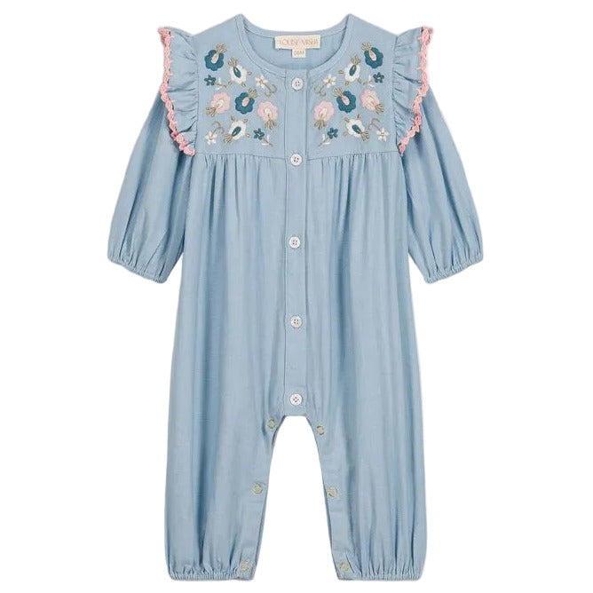 Discover the Baby Girls’ Lilette Jumpsuit by Louise Misha: a light blue romper designed with long sleeves, front buttons, and a delicately embroidered yoke adorned with floral accents on the chest. This charming piece also features ruffled shoulders highlighted with pink trim, hand-crocheted finishes for an extra special touch, and snap buttons at the legs for easy dressing.
