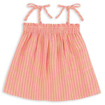 The Girls’ Swing Tank by Feather 4 Arrow features pink and yellow stripes, a flowy fit, adjustable tie tank straps, and a gathered, elasticized top with a ruched square neckline, shown against a white background.