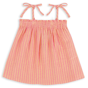 The Girls’ Swing Tank by Feather 4 Arrow features pink and yellow stripes, a flowy fit, adjustable tie tank straps, and a gathered, elasticized top with a ruched square neckline, shown against a white background.