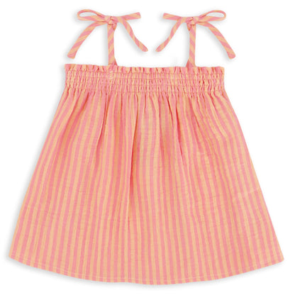 The Girls’ Swing Tank by Feather 4 Arrow features pink and yellow stripes, a flowy fit, adjustable tie tank straps, and a gathered, elasticized top with a ruched square neckline, shown against a white background.