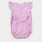 The Early Sunday Baby Girls’ Lucy Baby Bubble Romper, shown flat on a white background, features a light pink cotton-linen blend with ruffled detailing along the shoulders and a button-up back.