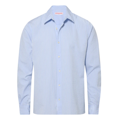 The Justin Seersucker Stripe shirt by Orlebar Brown is a light blue, long-sleeve, button-down shirt featuring subtle vertical stripes and crafted from 100% cotton for breathable summer comfort, displayed on a plain white background.