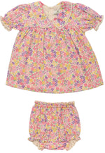 The Early Sunday Baby Girls’ Sofia Baby Dress & Bloomers set features a pink floral dress with short sleeves, crafted from soft organic cotton and paired with matching bloomers—both designed with elasticated edges for a comfortable fit.