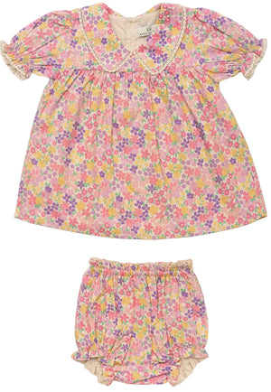 The Early Sunday Baby Girls’ Sofia Baby Dress & Bloomers set features a pink floral dress with short sleeves, crafted from soft organic cotton and paired with matching bloomers—both designed with elasticated edges for a comfortable fit.