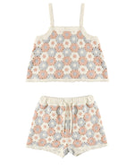 The Girls' Lili Knit Set by Rylee & Cru is a two-piece summer crochet outfit with a sleeveless crop top and drawstring shorts, showcasing pink, blue, and beige floral circular motifs for a breezy style.