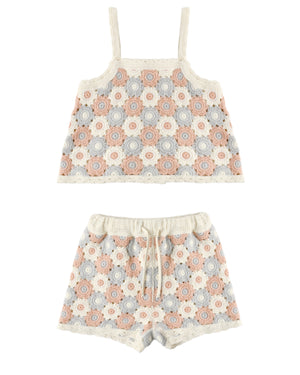 The Girls' Lili Knit Set by Rylee & Cru is a two-piece summer crochet outfit with a sleeveless crop top and drawstring shorts, showcasing pink, blue, and beige floral circular motifs for a breezy style.
