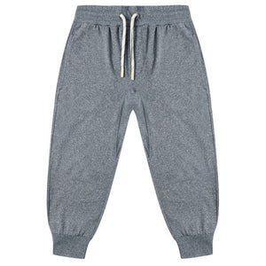 The Boys' Century Tech Jogger by Rylee & Cru features an elastic waistband, white drawstrings, side pockets, and ribbed cuffs for a relaxed fit. Versatile gray joggers shown laid flat on a white background.