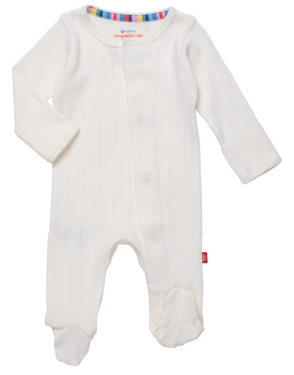 The Baby Love Lines Pointelle Footie by Magnetic Me, featuring subtle stripes and a colorful neckline, is a baby wardrobe essential. With convenient front snap closures and crafted from organic cotton, it ensures ultimate comfort.