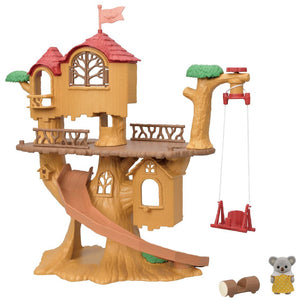 The Calico Critters Adventure Tree House Gift Set features a plastic treehouse toy with a slide, swing, balcony, a small gray animal figure, and a log accessory—all displayed against a white background. Part of the Adventure Tree House collection by Calico Critters, this delightful playset is ideal for imaginative family adventures.