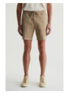 A person wearing a white t-shirt, the AG Jeans Oliver Short in beige with a drawstring, and beige sneakers stands against a plain light background.