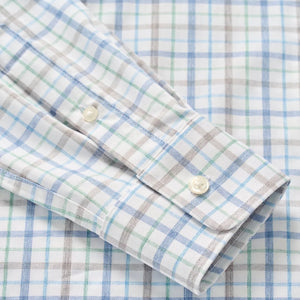 Close-up of the Johnnie-O Maarten Button Down, a wrinkle-resistant shirt with a white base and blue, green, and brown plaid pattern, featuring a buttoned cuff.