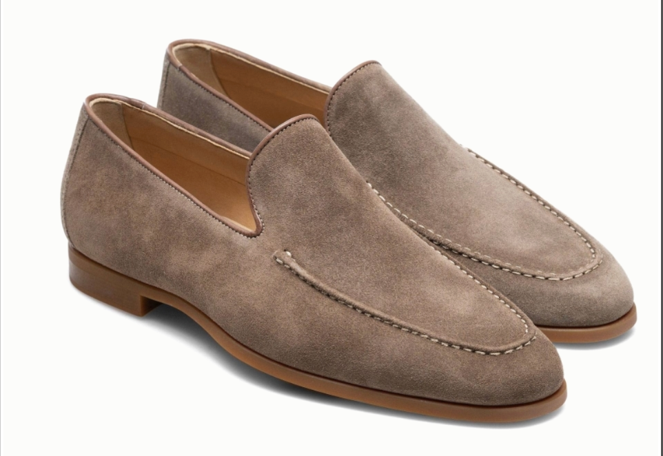 The Magnanni Lecera Loafer features tan suede with stitching detail, an apron toe, brown leather soles, and Bologna construction. Displayed against a white background.